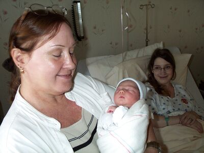 Grandma Diane holding me…everyone with eyes closed…Mommy in background