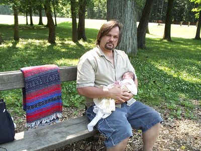 Daddy holding me on the bench