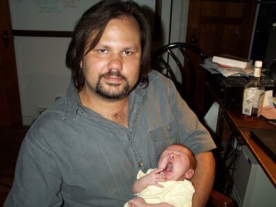 Daddy holding me while I'm yawning