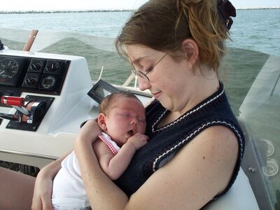 Close up of Mommy holding me on the boat
