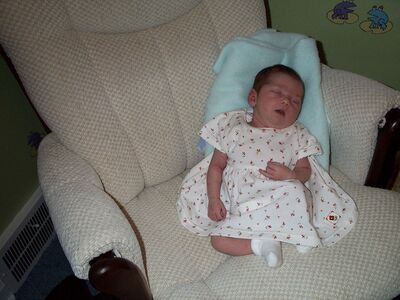 Me asleep in the rocking chair, flowered dress
