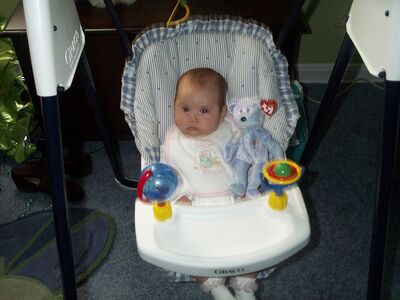 Me in the swing with my Mommy bib