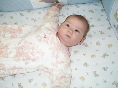 Me in pink toile outfit in crib