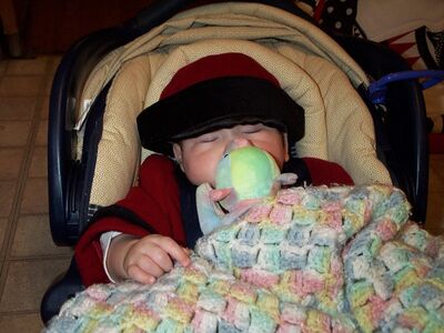Me asleep with red coat and hat on