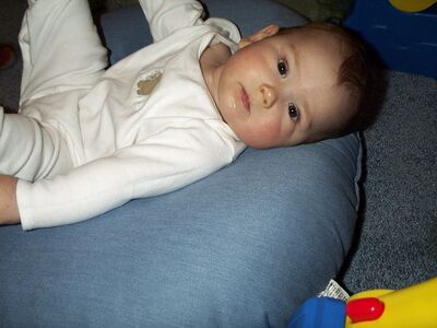 Me in the white puppy outfit…feet in air