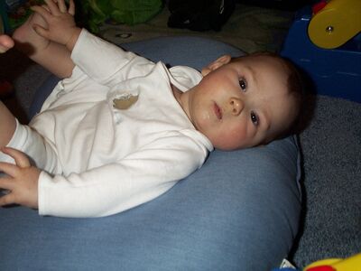 Me in the white puppy outfit…feet in air