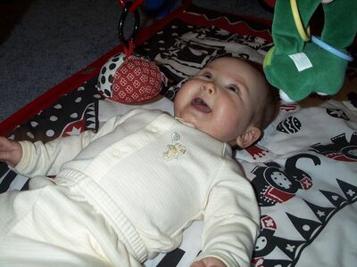 Me in striped outfit on playgym smiling