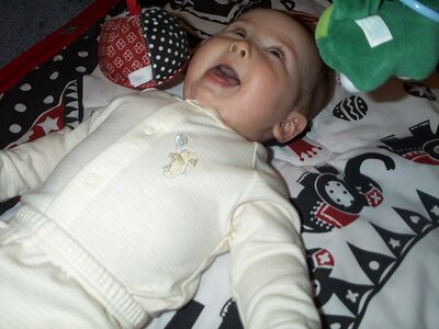 Me in striped outfit on playgym smiling
