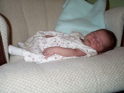 Me asleep in the rocking chair, flowered dress (cute)