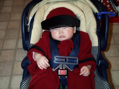 Me asleep with red coat and hat on